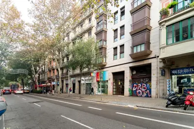 a city street with buildings and a motorcycle parked on the street at Comfy Downtown + Private terrace in Barcelona