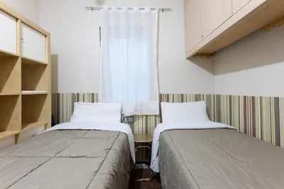 two beds sitting next to each other in a room at Aparteasy - Bright, large and central apartment in BCN in Barcelona