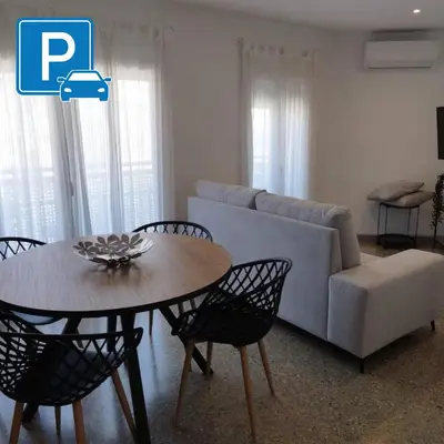 a living room with a couch and a table and chairs at Apartament IXA-2 in Manresa