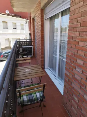 a balcony with a wooden table and a bench at Apartament IXA-2 in Manresa