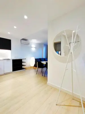 a living room with a table and a mirror at Moderno Apartamento en Terrassa Centro in Terrassa