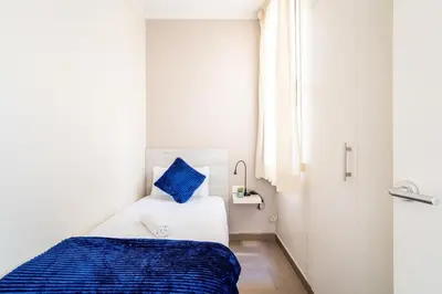 a living room with a couch and a table at The Collection Barcelona - Eixample next to Paseo de Gracia modern 3BD in Barcelona
