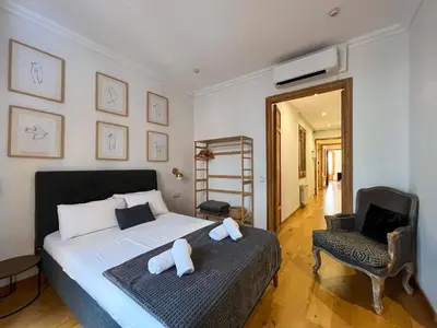 a bedroom with a bed with two stuffed animals on it at Stay U-nique Apartments Mistral II in Barcelona