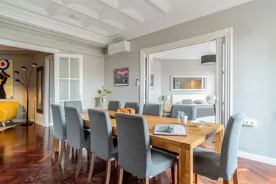 a dining room with a wooden table and chairs at Canela Homes BARCELONA EIXAMPLE in Barcelona