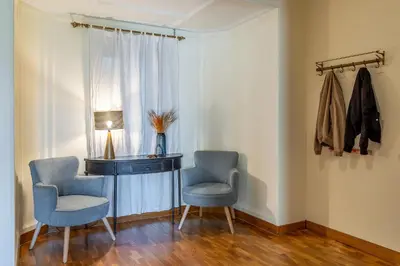 a room with two chairs and a desk and a lamp at Canela Homes BARCELONA MODERNISTA in Barcelona