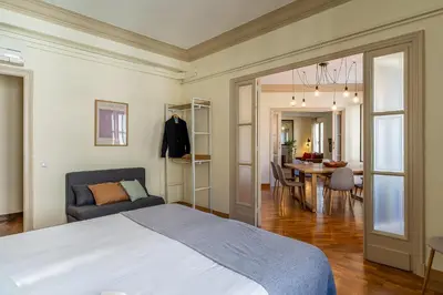 a bedroom with a bed and a dining room at Canela Homes BARCELONA MODERNISTA in Barcelona