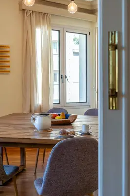a dining room table with a bowl of fruit on it at Canela Homes BARCELONA MODERNISTA in Barcelona