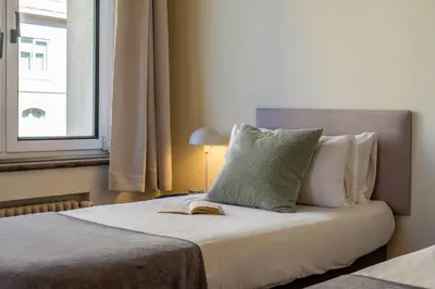 a bedroom with a bed with a book on it at Canela Homes BARCELONA MODERNISTA in Barcelona