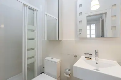 a bathroom with a toilet and a sink and a mirror at Canela Homes BARCELONA RAMBLA CAT in Barcelona