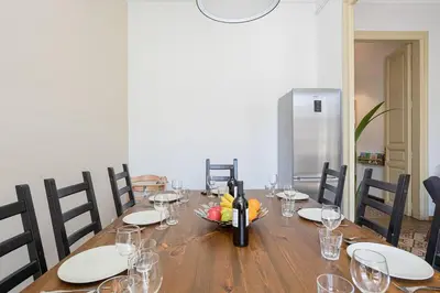 a wooden table with glasses and a bottle of wine at Canela Homes BARCELONA CONSELL in Barcelona