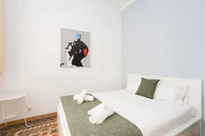 a bedroom with a bed and a picture on the wall at Canela Homes BARCELONA CONSELL in Barcelona