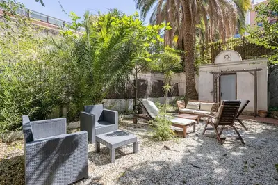 a group of chairs and tables in a yard at Canela Homes BARCELONA CONSELL in Barcelona