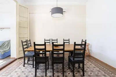 a dining room with a wooden table and chairs at Canela Homes BARCELONA CONSELL in Barcelona