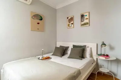 a white bedroom with a bed with a bowl on it at Canela Homes BARCELONA DIPUTACIÓ in Barcelona