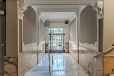 an empty hallway with a glass door and a window at Canela Homes BARCELONA BAILÉN in Barcelona