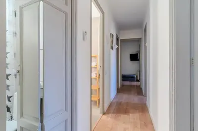 a hallway with a mirror in a white room at Canela Homes BARCELONA BAILÉN in Barcelona