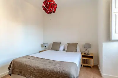 a bedroom with a bed and a red bag on the wall at Canela Homes BARCELONA BAILÉN in Barcelona