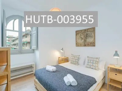 a bedroom with a bed with two towels on it at Canela Homes BARCELONA BAILÉN in Barcelona