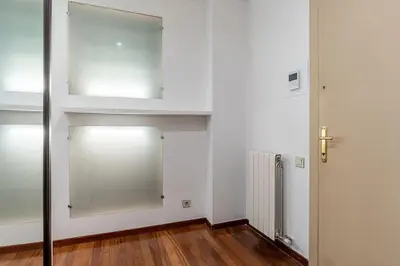 a white room with a door and a mirror at Canela Homes BARCELONA ARAGÓ in Barcelona