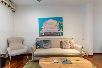 a living room with a couch and a table at Canela Homes BARCELONA ARAGÓ in Barcelona