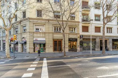 an empty street in front of a large building at Canela Homes BARCELONA ROSSELLÓ in Barcelona