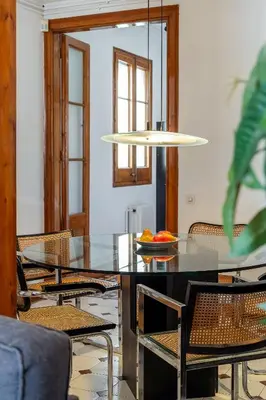 a dining room with a glass table and chairs at Canela Homes BARCELONA VLC306 in Barcelona