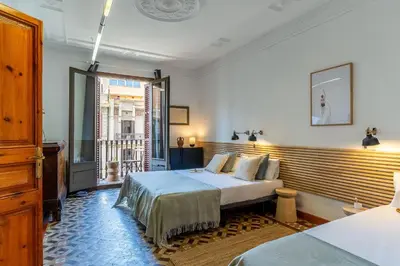 a bedroom with two beds and a window at Canela Homes BARCELONA VLC306 in Barcelona