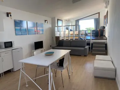 a living room with a white table and a couch at LOFT CAL XURIGUER in Font-Rubí