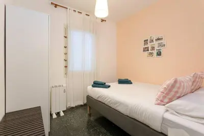 a small bedroom with a bed and a mirror at Canela Homes BARCELONA PARK GÜELL in Barcelona