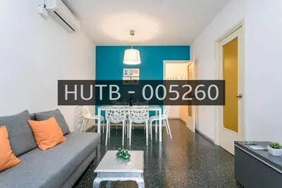 a living room with a couch and a table at Canela Homes BARCELONA PARK GÜELL in Barcelona