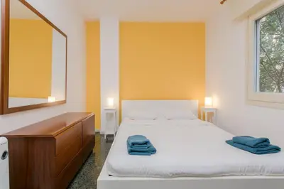 a bedroom with two beds and a dresser and a mirror at Canela Homes BARCELONA PARK GÜELL in Barcelona