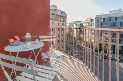 a balcony with a table with a bowl of fruit on it at Canela Homes BARCELONA COZY in Barcelona