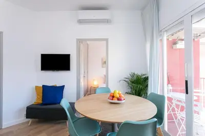 a living room with a table and chairs at Canela Homes BARCELONA COZY in Barcelona