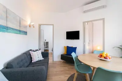 a living room with a couch and a table at Canela Homes BARCELONA COZY in Barcelona