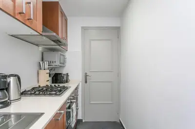 a kitchen with a stove and a white door at Canela Homes BARCELONA COZY in Barcelona