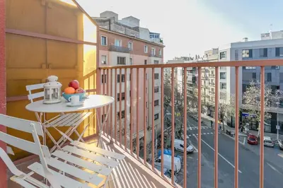 a balcony with a table with a bowl of fruit on it at Canela Homes BARCELONA COZY in Barcelona