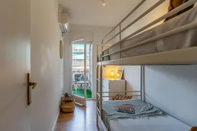 a bedroom with two bunk beds and a hallway at Canela Homes COSTA CASTELLDEFELS in Castelldefels
