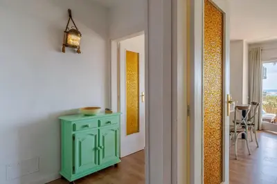 a green cabinet in a room with a hallway at Canela Homes COSTA CASTELLDEFELS in Castelldefels