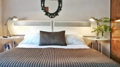 a bedroom with a bed with a mirror on the wall at Auditori Barcelona in Barcelona