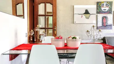 a dining room with a table with white chairs at Auditori Barcelona in Barcelona