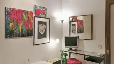 a room with a desk with a computer and some paintings at Auditori Barcelona in Barcelona