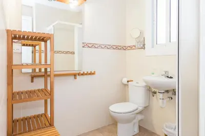 a bathroom with a toilet and a sink at Fira Suites in Barcelona