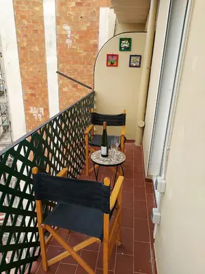 a balcony with a table with a bottle of wine at Fira Suites in Barcelona