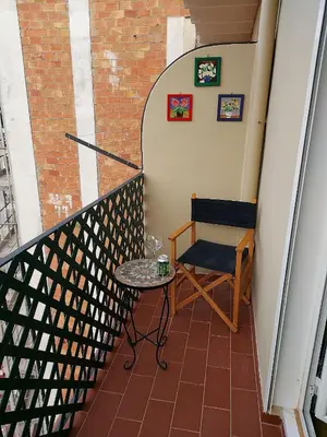 a stairway with a chair and a table in a room at Fira Suites in Barcelona