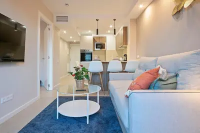 a living room with a couch and a table at YOUR HOME - Camp Nou Apartment in Hospitalet de Llobregat
