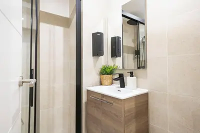 a bathroom with a sink and a mirror at YOUR HOME - Camp Nou Apartment in Hospitalet de Llobregat