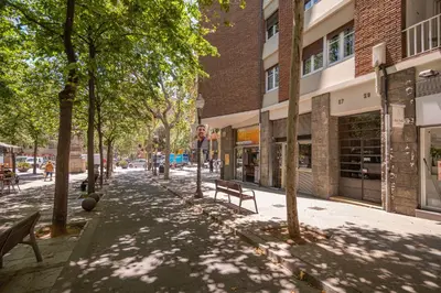 a street with trees and benches in a city at Stay U-nique Apartments Gaudi III in Barcelona