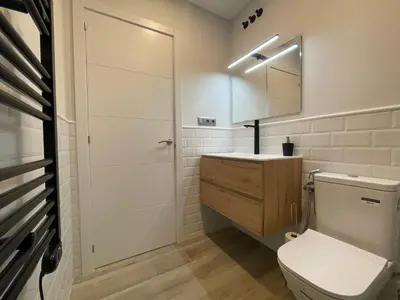 a bathroom with a toilet and a sink and a mirror at manresa universidad in Manresa