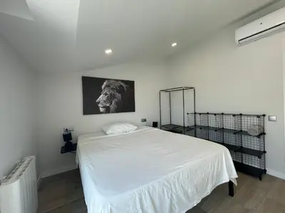 a bedroom with a white bed and a picture on the wall at manresa universidad in Manresa
