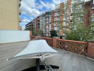 a white hammock on a balcony with buildings at manresa universidad in Manresa